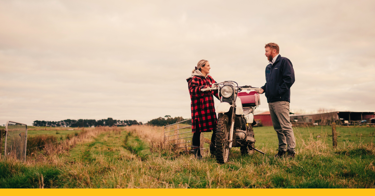 Man and woman with farm bike talking on-farm